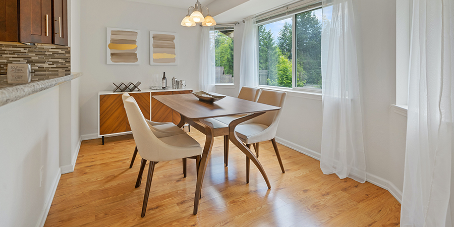 a classic wooden dining table with four wooden chairs