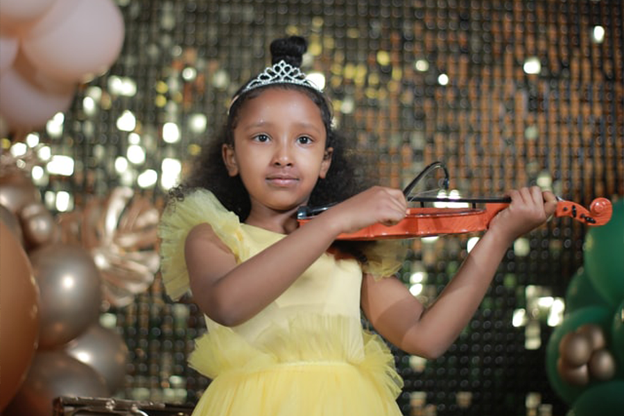 Girl in a yellow dress playing the violin