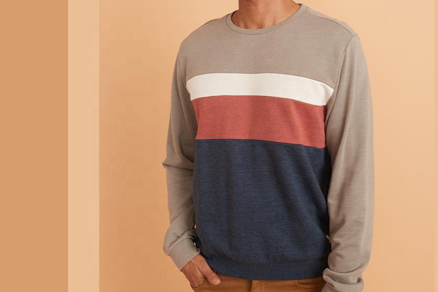 Man wearing a retro crewneck sweatshirt in multiple colors