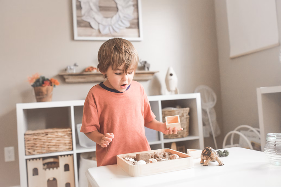 Boy standing in front of a white table