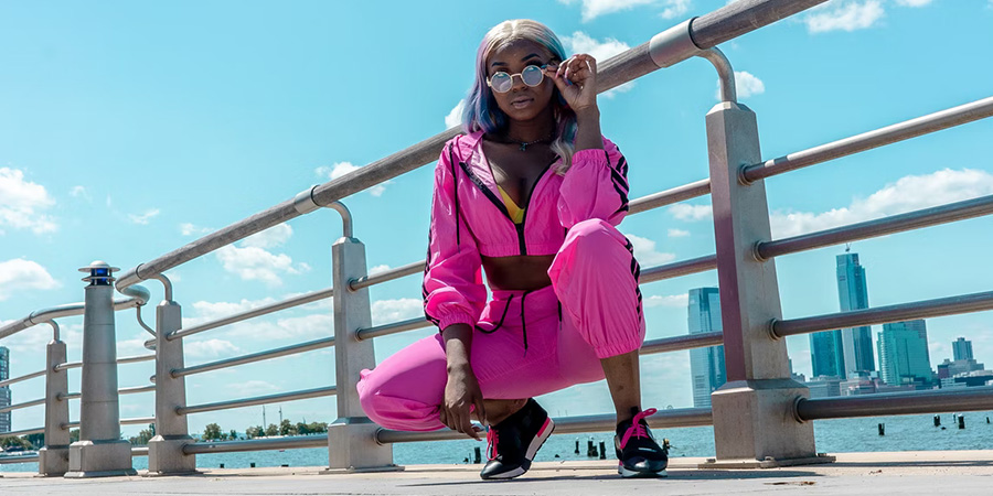 Woman in a neon pink athleisure outfit