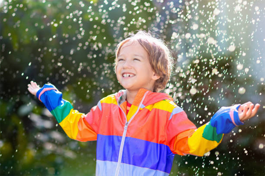 Boy in summer style light rainbow jacket