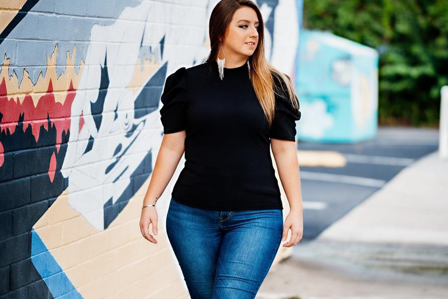 Plus-size woman rocking blue denim and black top