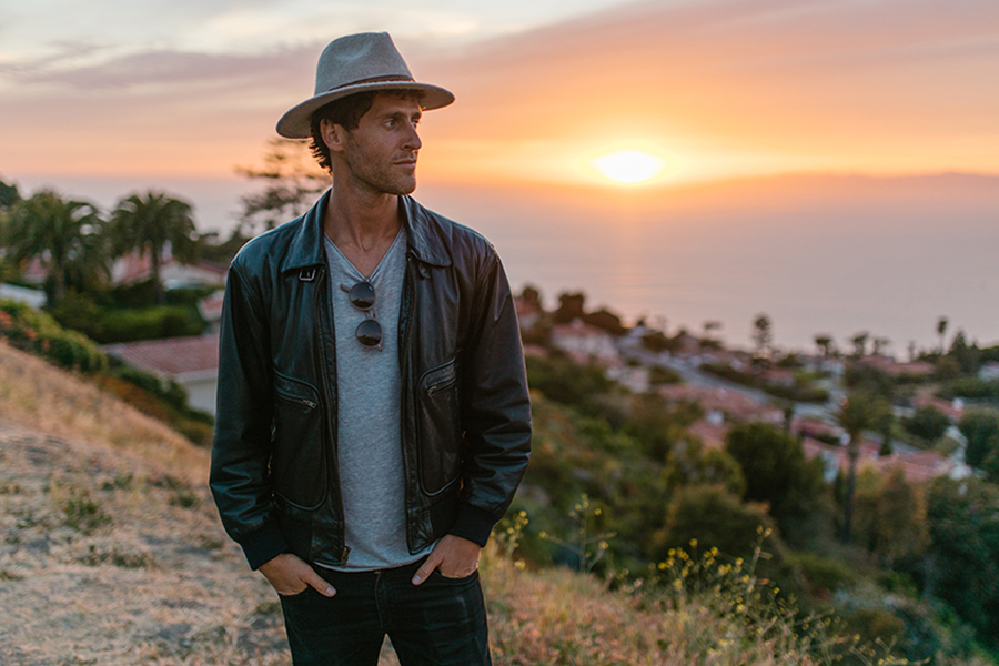 Man wearing Perfecto jacket with a T-shirt, hat, and denim