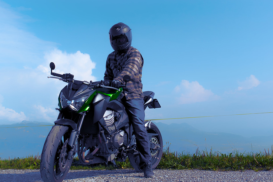 Biker sitting on a motorcycle while rocking an armored shirt