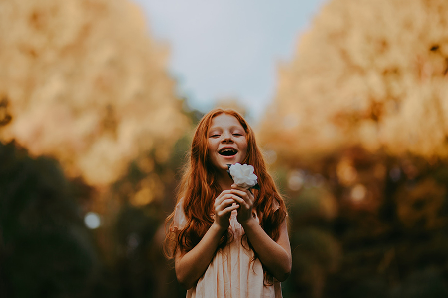 Beautiful little girl rocking a lilac linen dress in the sunset