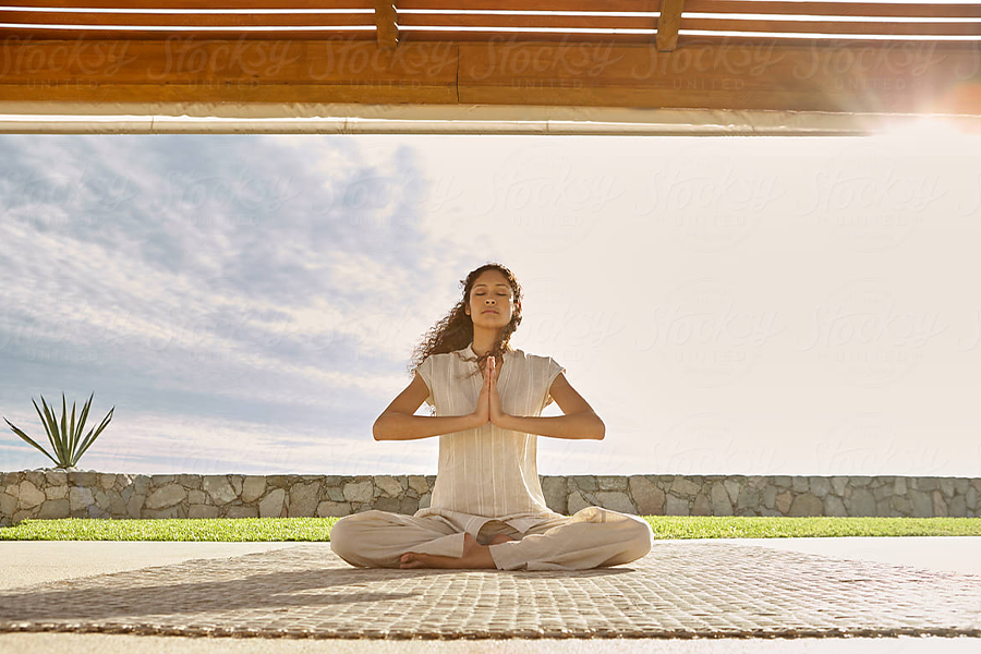 Woman holding a sitting down yoga pose in flare leggings