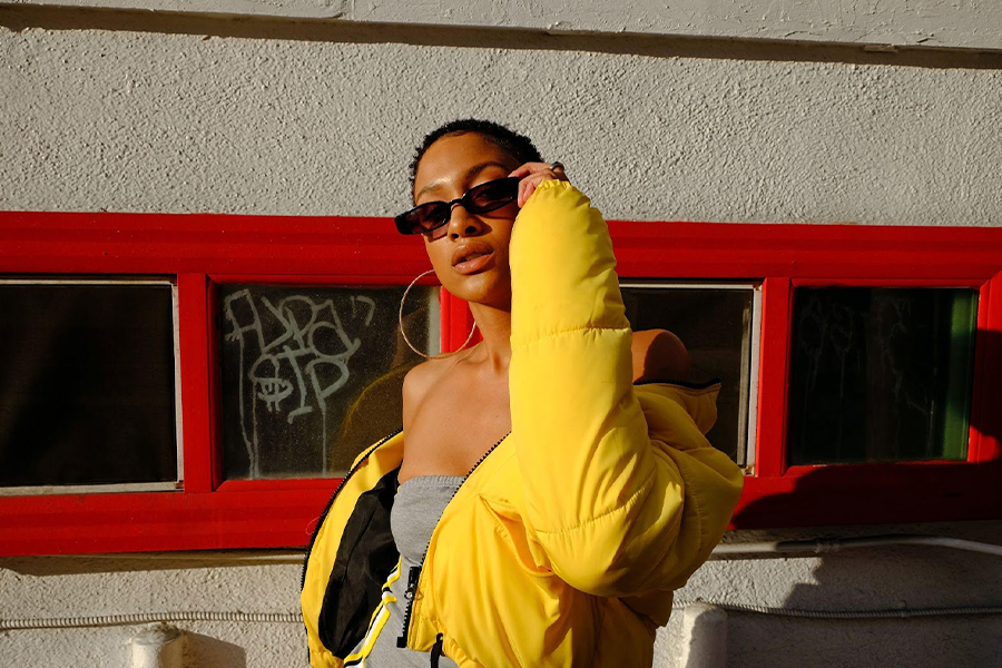 Woman in dress and bomber jacket