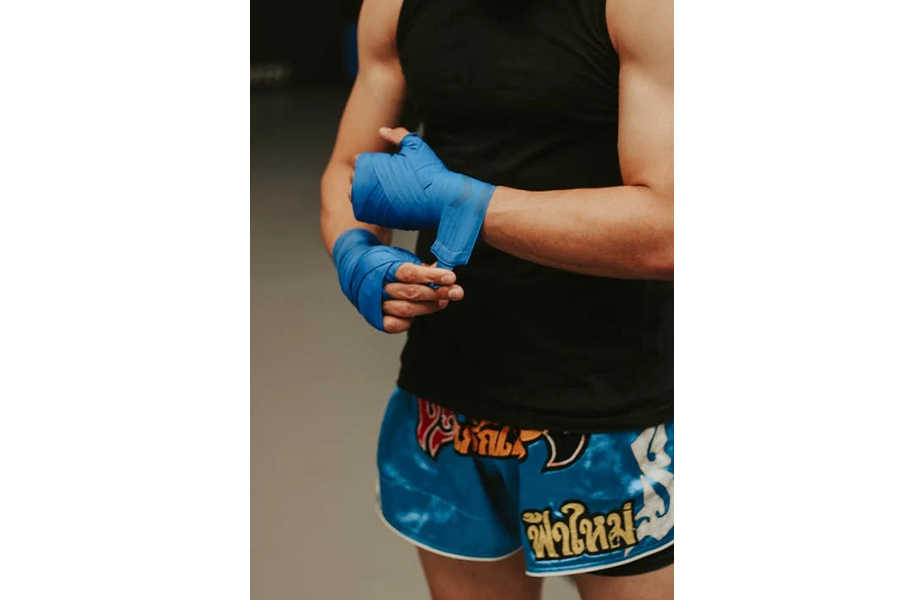 Man wearing back tank top vest and printed shorts