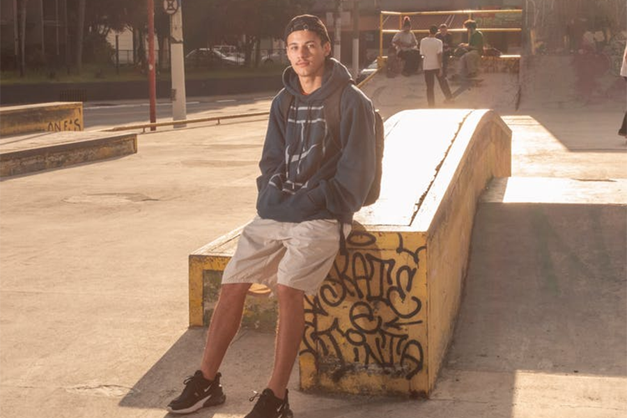 Young man wearing hooded sweatshirt with discrete pockets