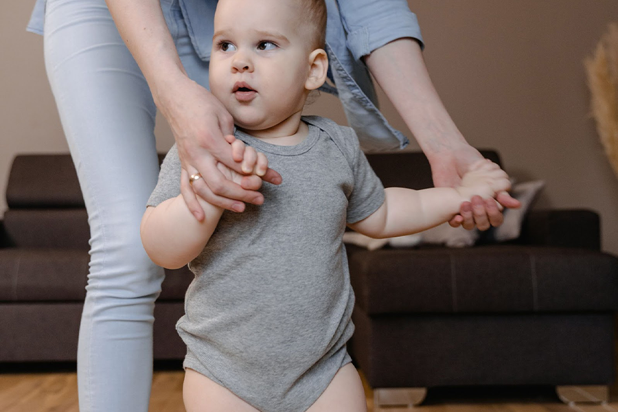 Toddler posing with his mom on gray terry toweling