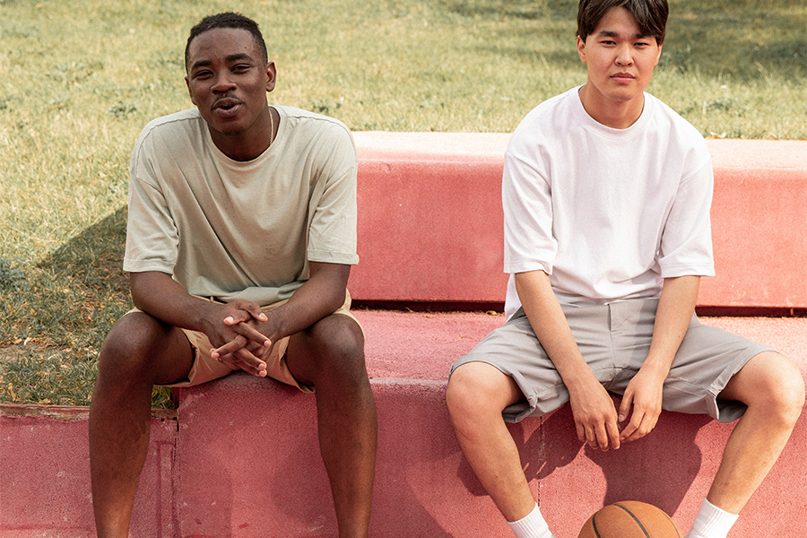 Two young men in activewear tops and bottoms