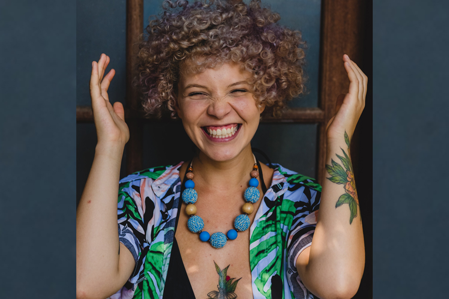 Smiling woman in green and blue Hawaiian-print top