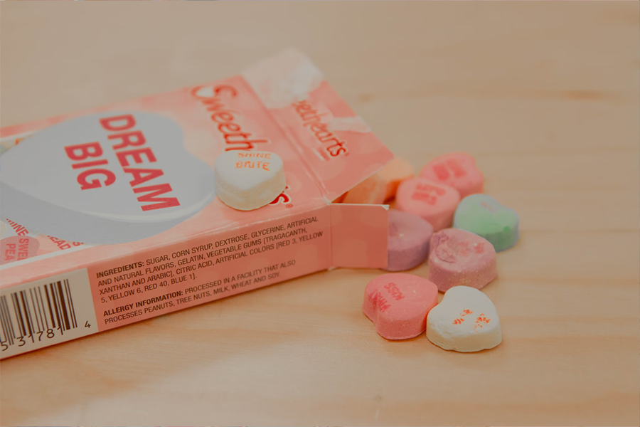 Heart-shaped candies stored in a paper box