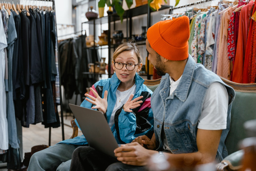 Lady sitting with a man in a store making gestures