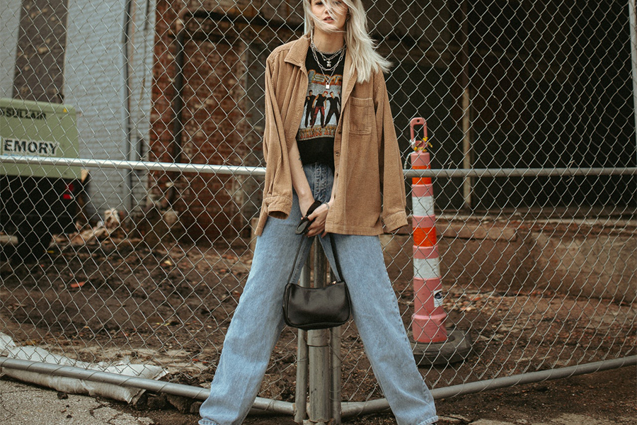 Blondie in blue boyfriend jeans and brown jacket