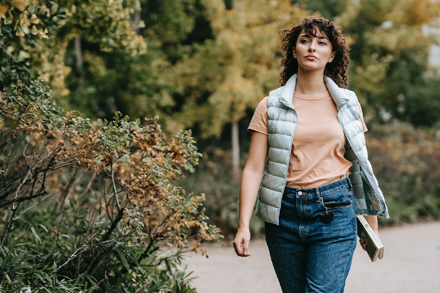 Lady in teal orange top and olive green padded gilet