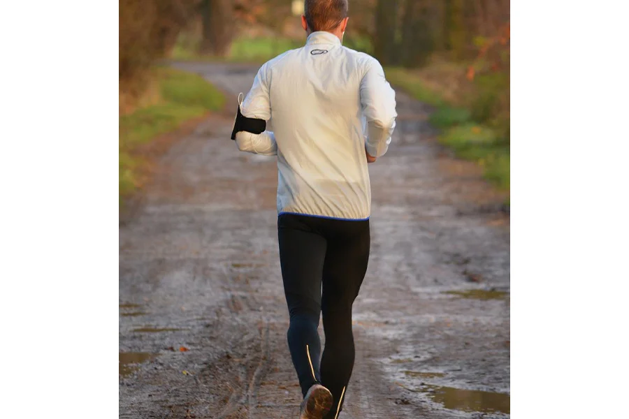 A man wearing black joggers running