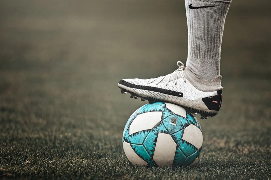 A white varied ground cleat resting on a ball