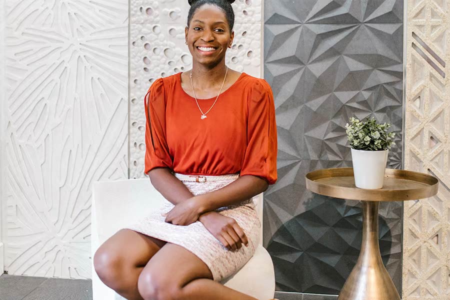 African American Lady in red top and cream skirt