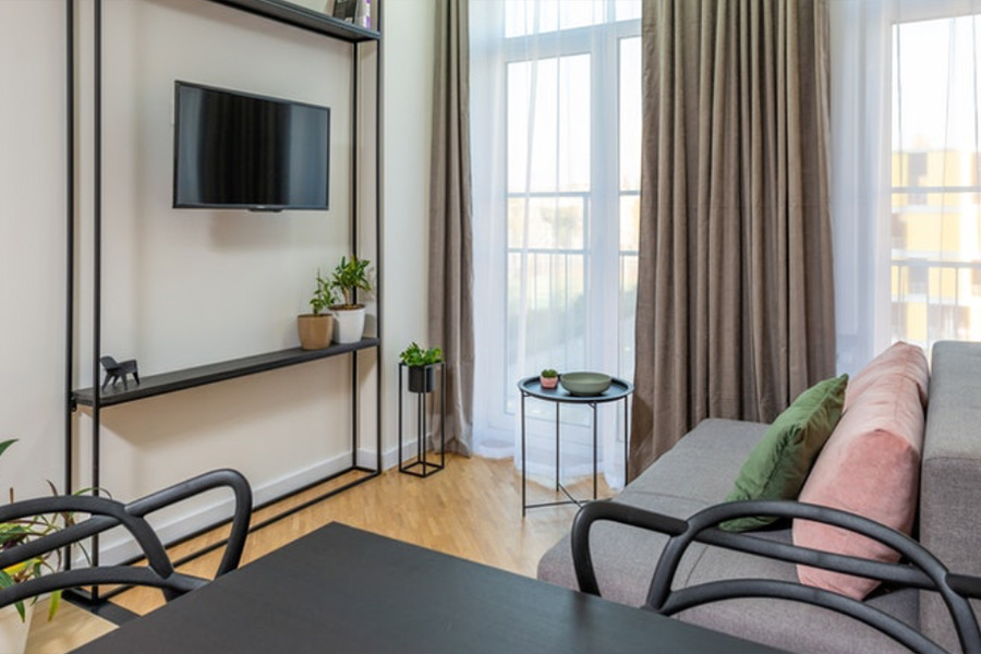 industrial-style black tv stand next to windows