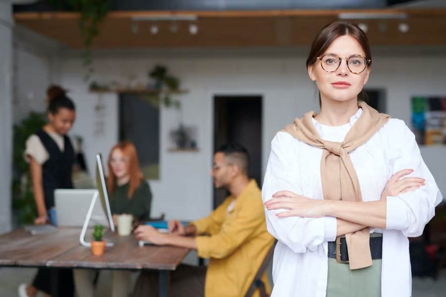 Lady in white shirt with sweater around her neck