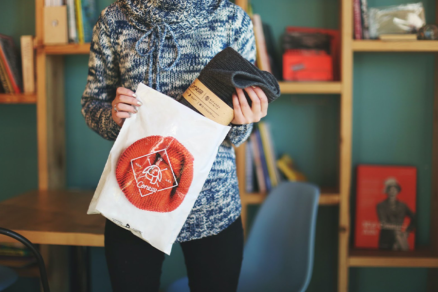 Large plastic ziplock bag being held with a scarf inside