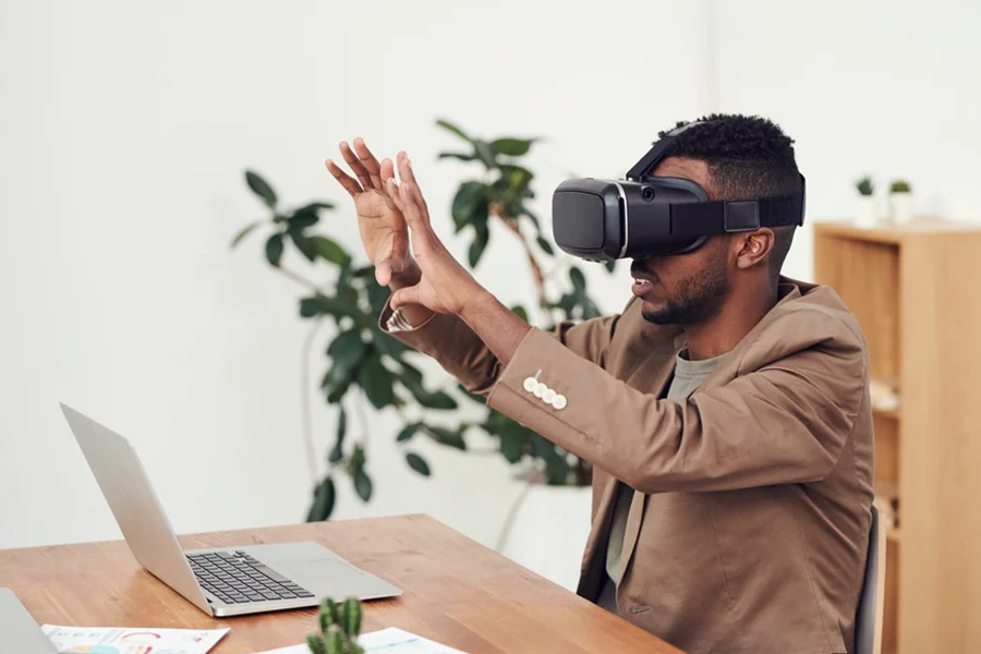 Man in brown jacket wearing VR headsets