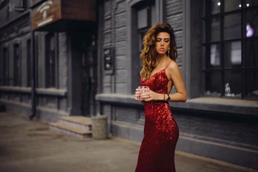 Woman in long red sequin party dress