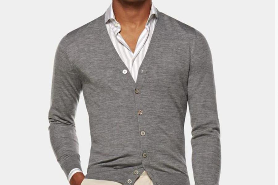 A man wearing a gray cardigan sweater