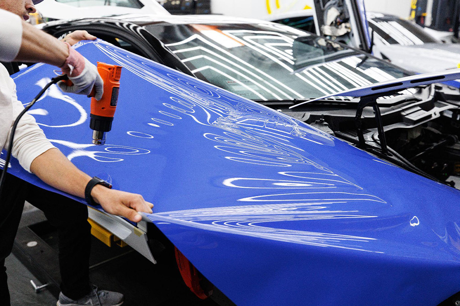 A man installing blue vinyl film