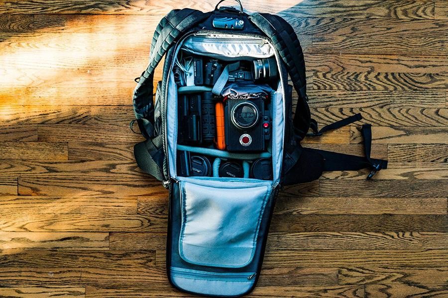 Backpack storing different filming equipment