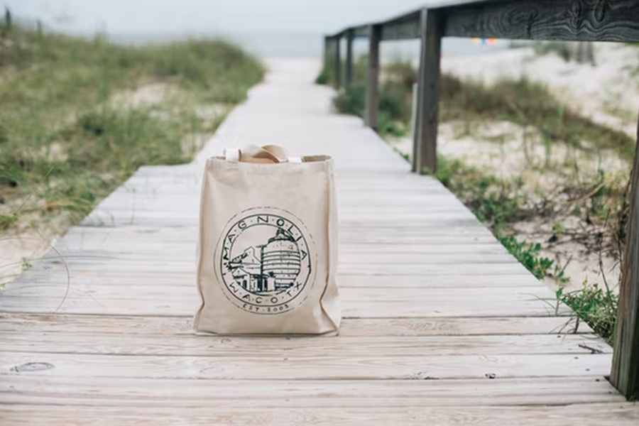 Cream canvas shopping bag on a boardwalk at the beach