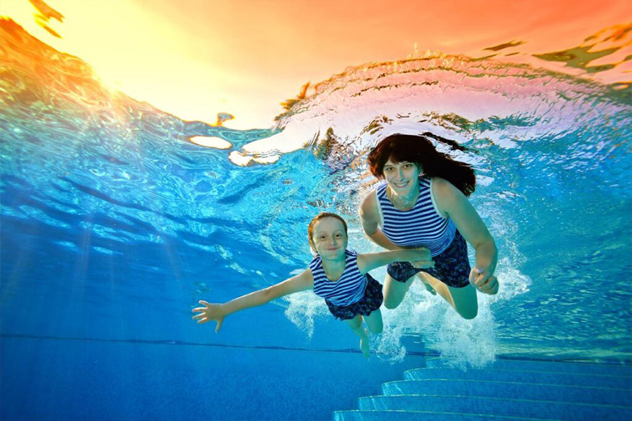 Mother And Daughter Swimming Wearing Matching Swimsuits