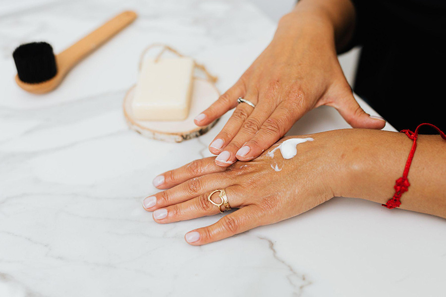 Person applying lotion on their hands