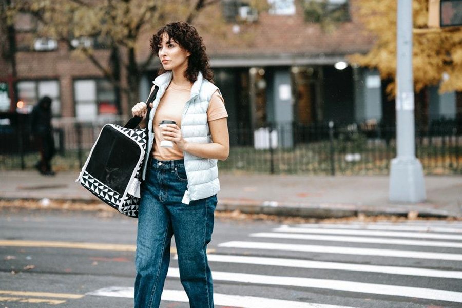 Silver padded vest over top and denim pants