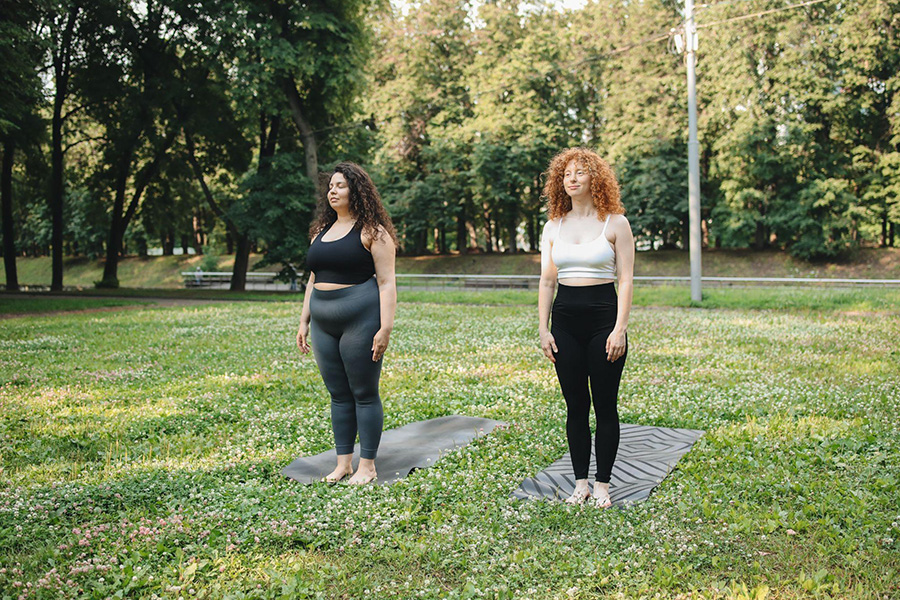 Two women doing yoga in compression leggings