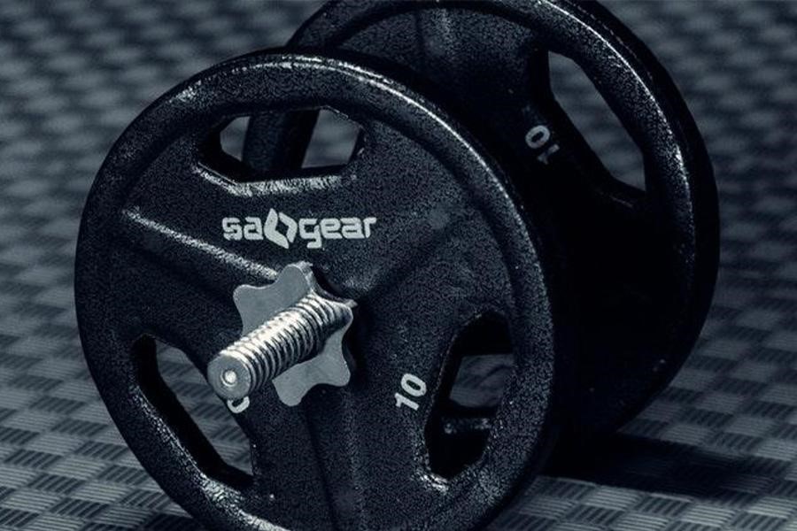 Dumbbell on a rubber mat in sports hall