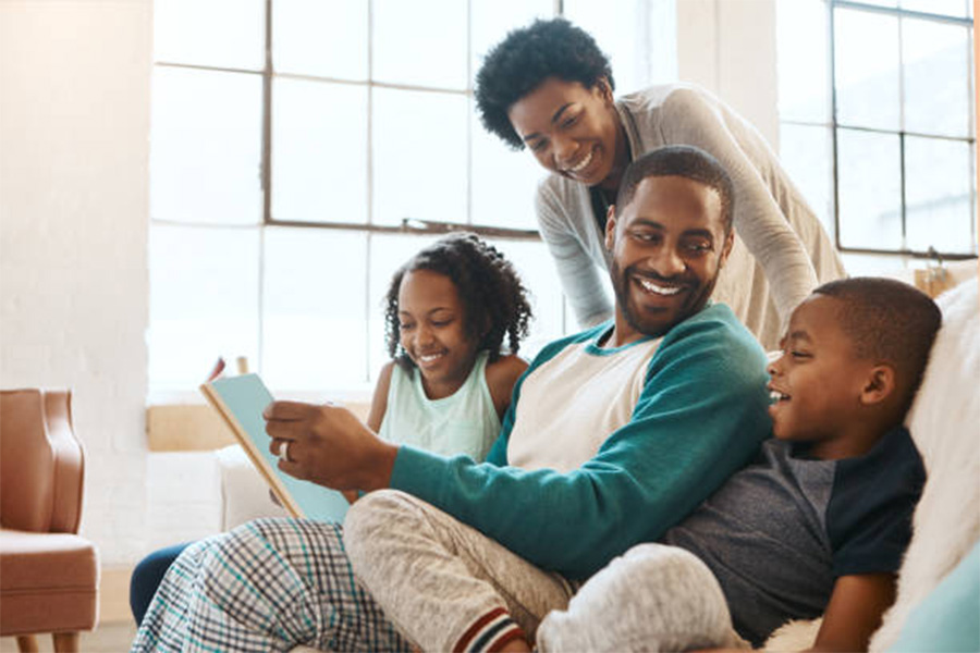 Family of four in comfortable cotton pajamas in living room