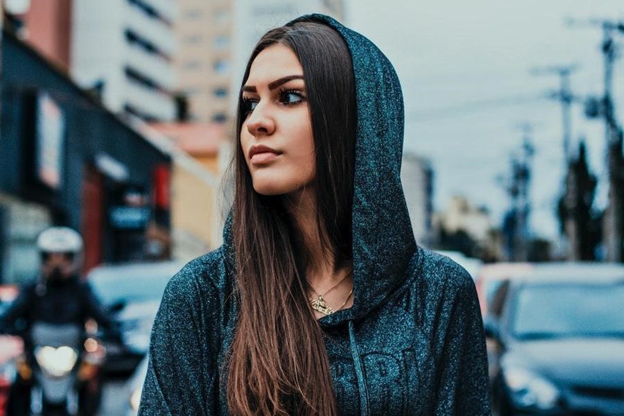 Lady wearing a shiny dark blue hoodie