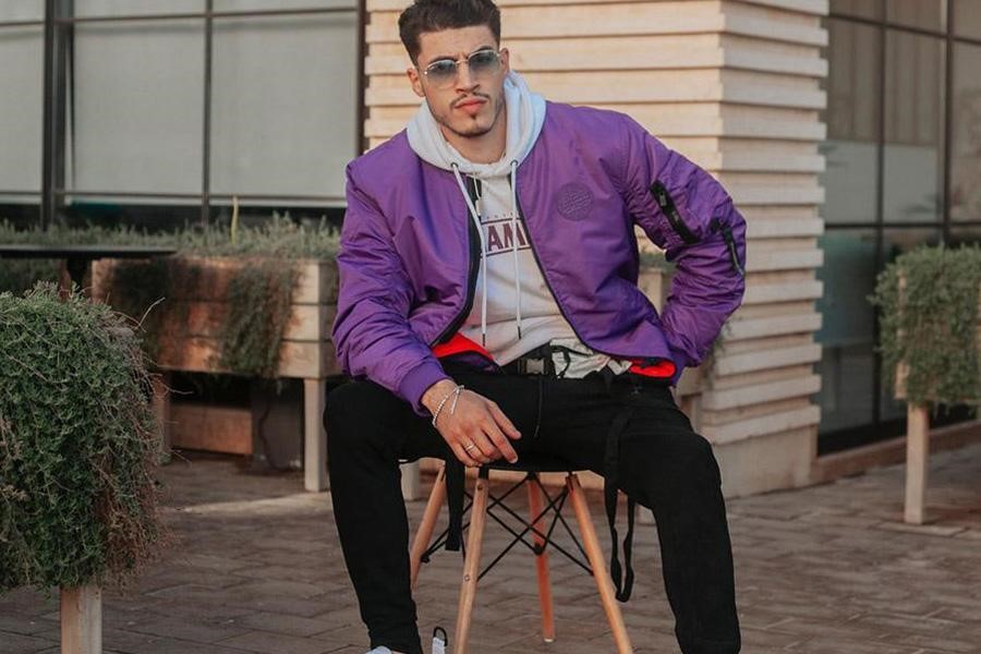 Man wearing a purple bomber jacket