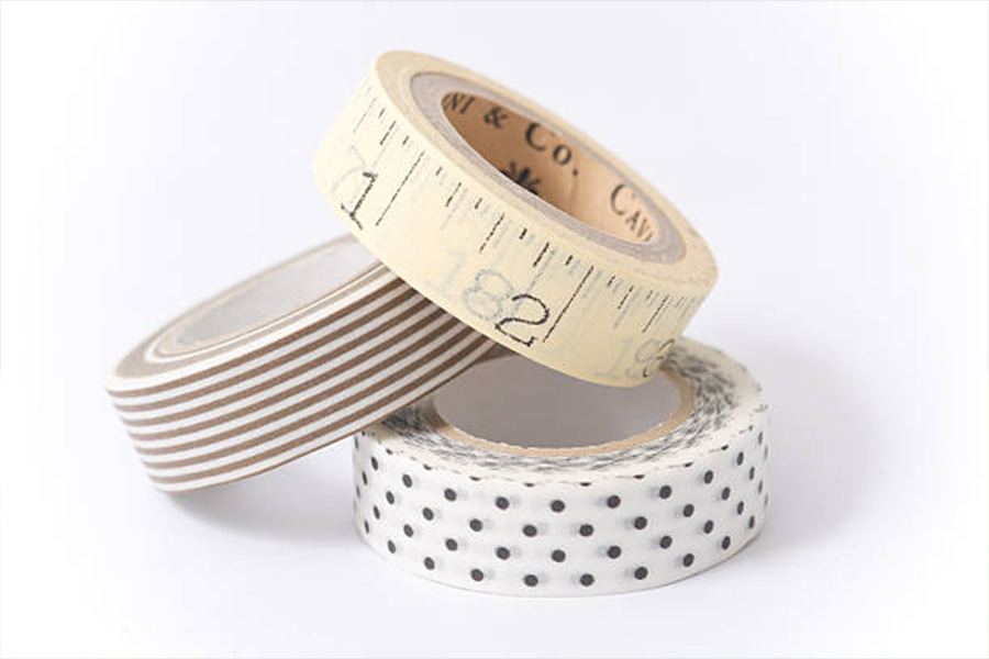 Three rolls of washi tape with different patterns on them