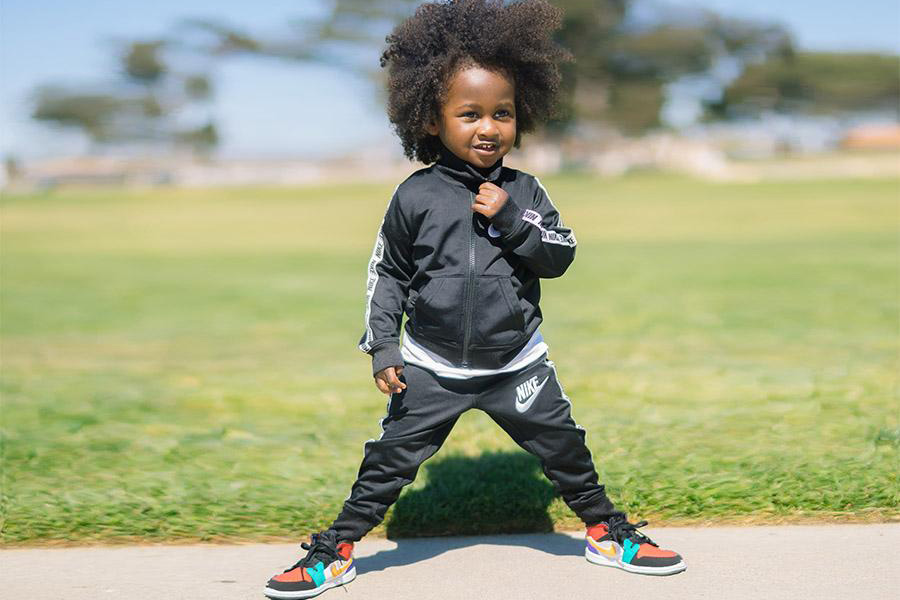 Toddler boy wearing a black sweat suit set