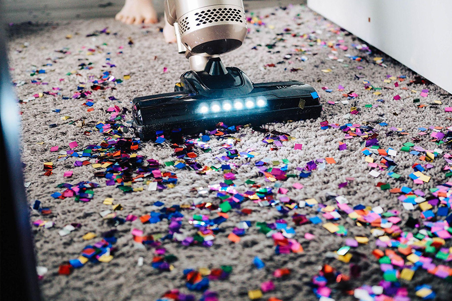 A vacuum cleaner on a messy carpet