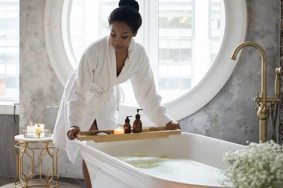 Woman about to take a bath with natural light