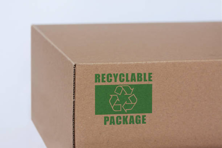 Cardboard box with recyclable package logo in green