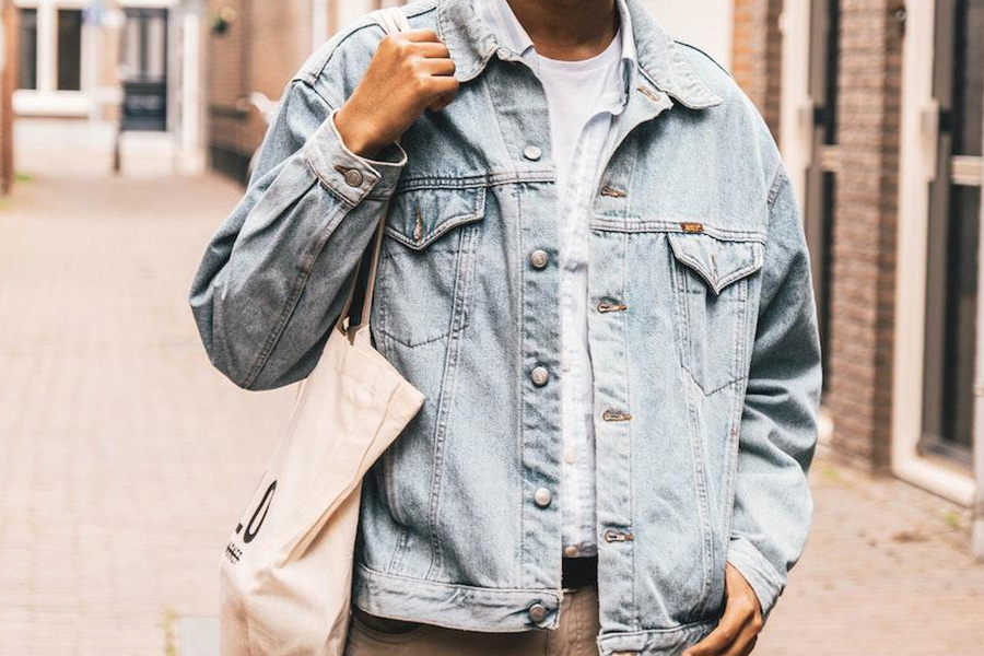 Man rocking jean bomber jacket with big buttons