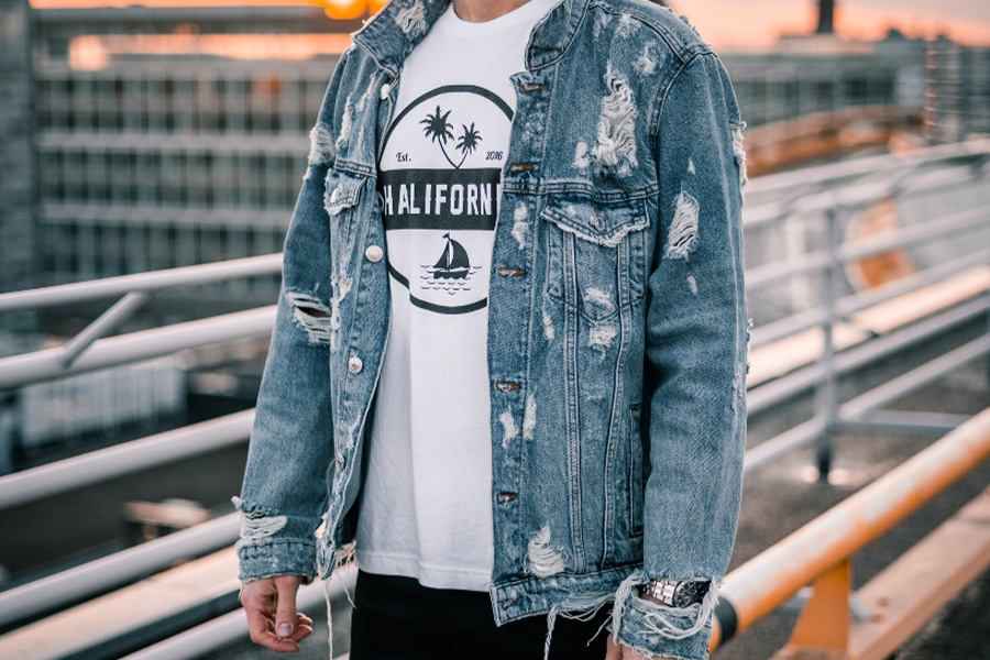 Man wearing distressed denim jacket