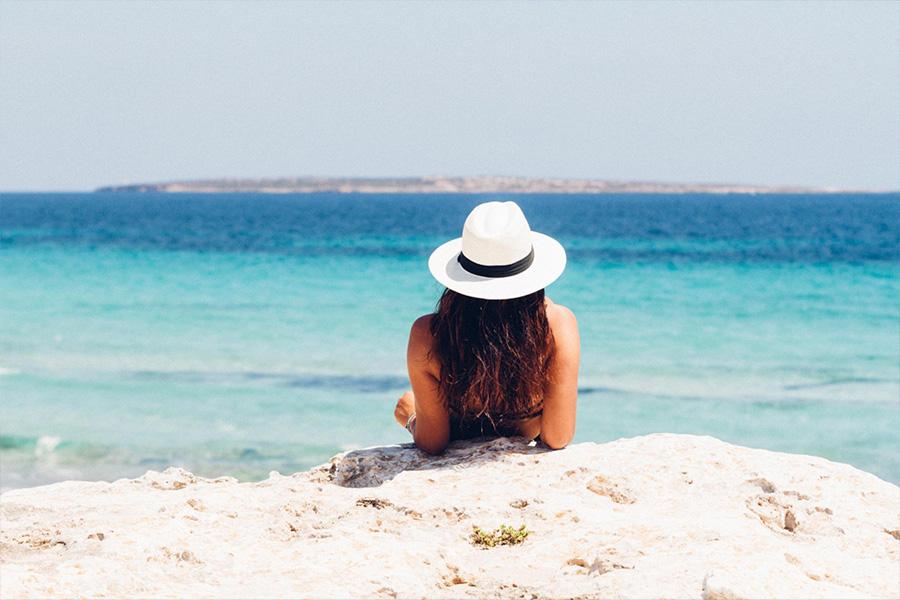 A woman relaxing on vacation by the sea