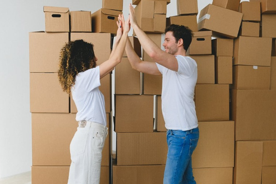 Excited business owners high-fiving after hitting their inventory turnover target